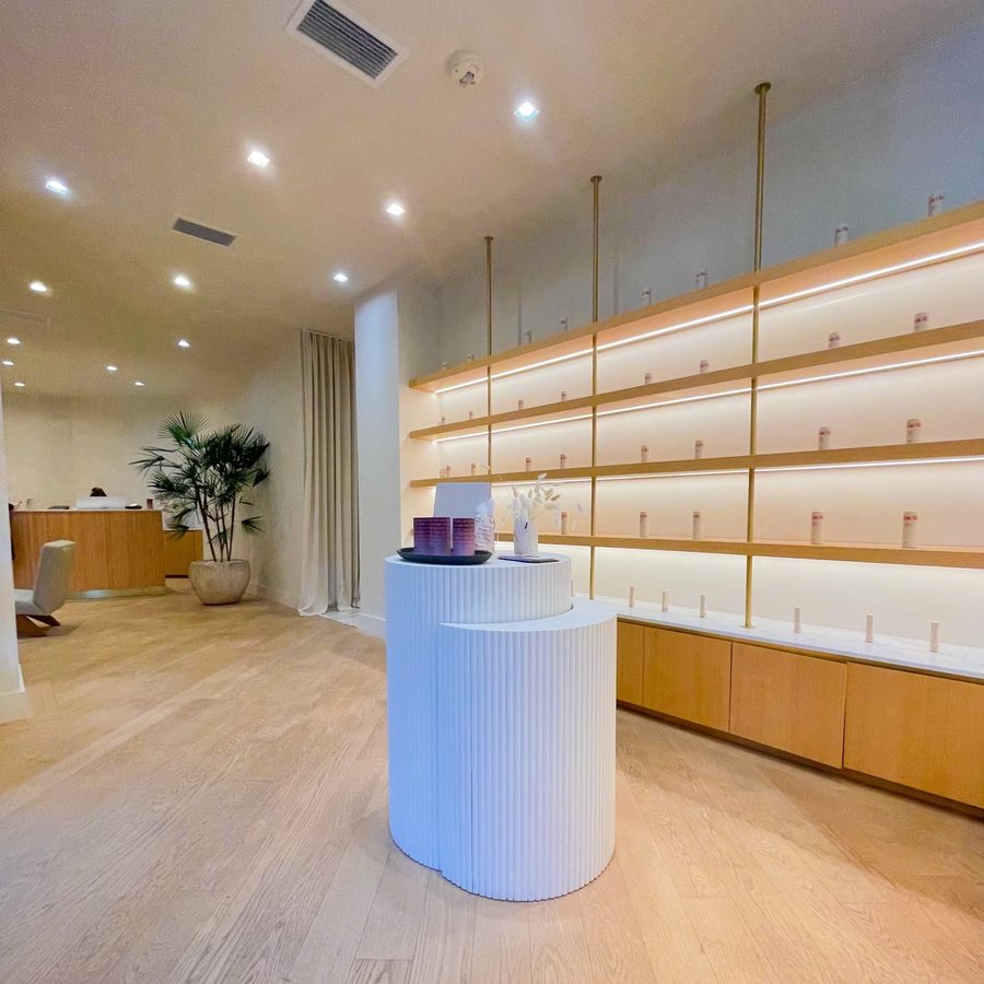 Wide interior view of the Facile flagship with product pedestal and shelving wall