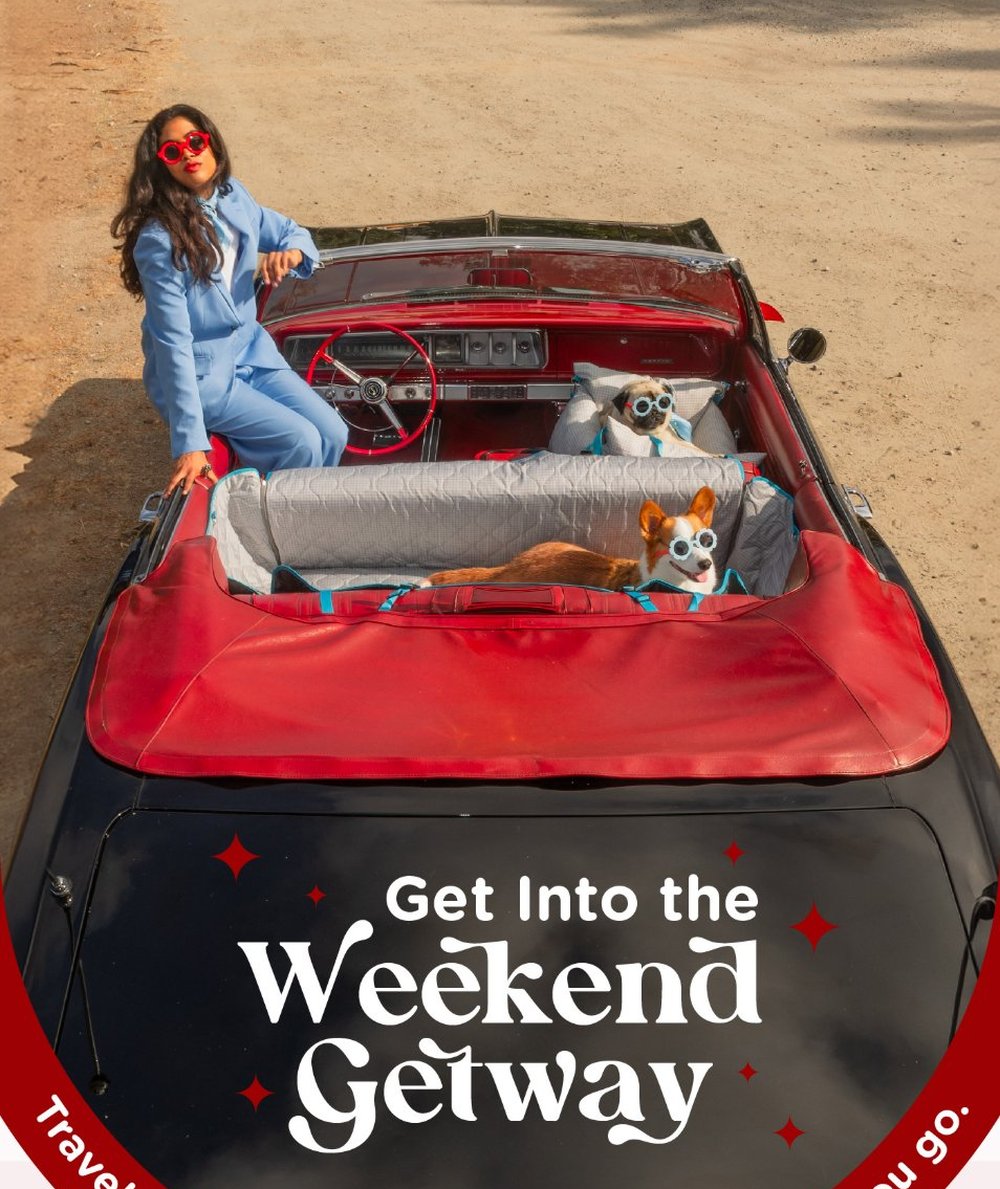 Weekend Getaway travel campaign email hero, woman and two dogs in sunglasses riding in a vintage red convertible