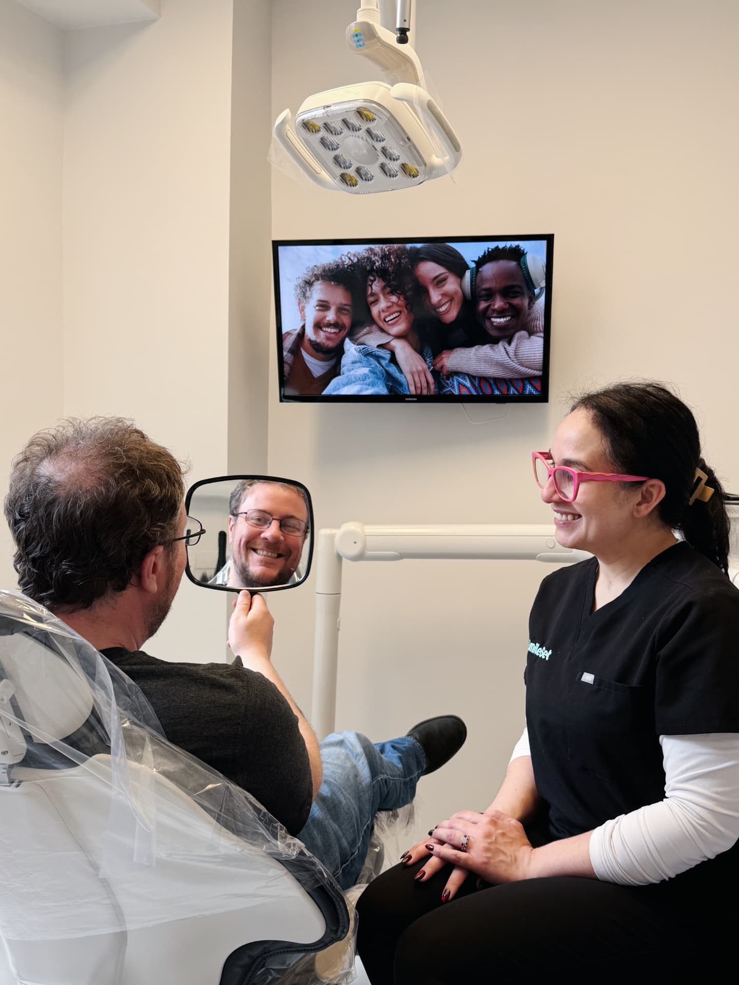 Patient and SmileSet team member sharing a lighthearted moment in the treatment chair