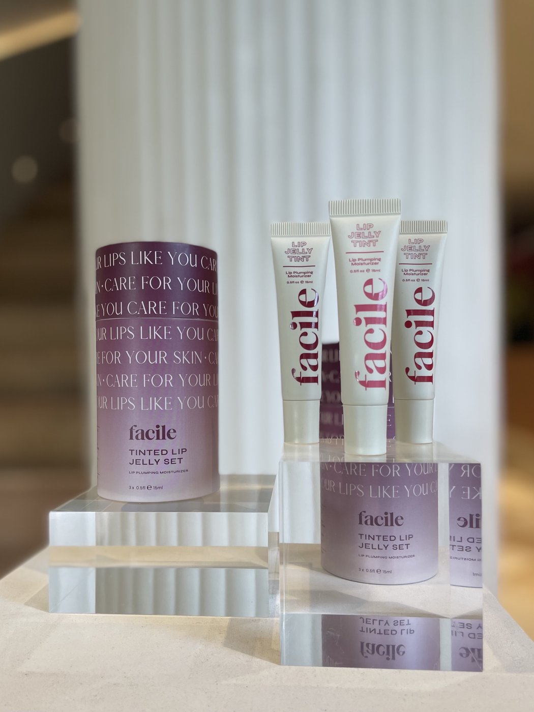 Facile Lip Jelly Tint tubes and Tinted Lip Jelly Set displayed on acrylic blocks