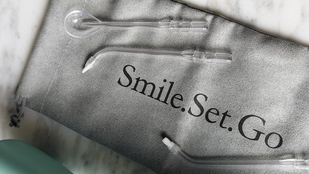 Smile.Set.Go travel bag flat lay with oral care tools